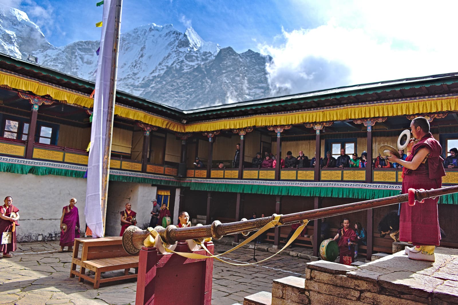 Monks sounding long horns in the courtyard of Tengboche Monastery during Mani Rimdu
